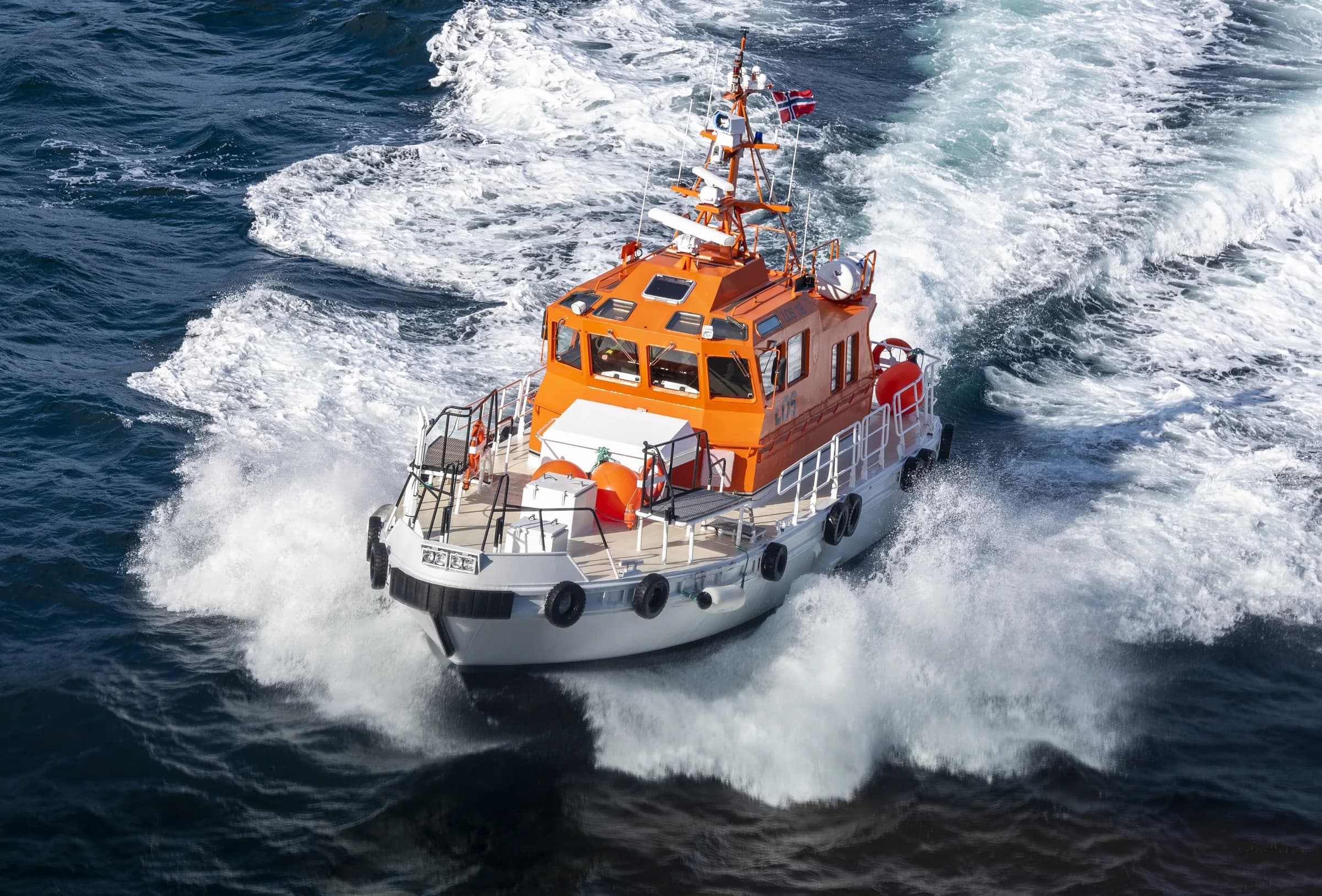 Arbetsbåt i fart ute på havet